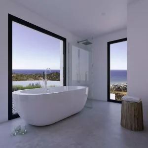 Cuarto de baño con vistas al mar del proyecto Camarate diseñado para Bass Houses